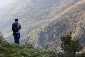 Naklejka na ściany i meble Hiker on the summit of a mountain in matese park