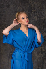 Beautiful breast in blue bathrobe