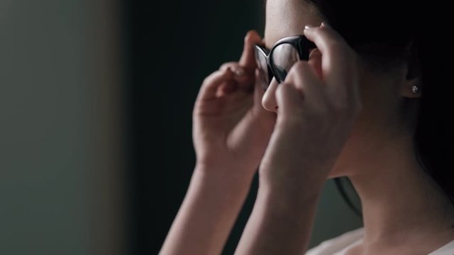 Woman wearing optical eyeglasses - profile view