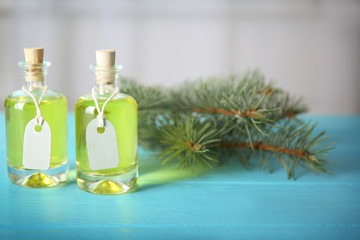 Obraz na płótnie Canvas Bottles of pine essential oil on wooden table