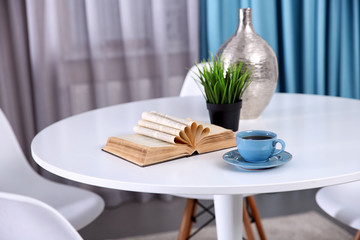 Cup of delicious tea on white table