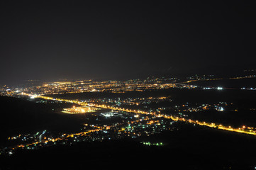 Naklejka premium City lights in the night, Nis, Serbia at night view on the city from the hill at night.