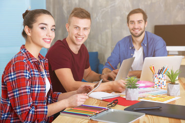 Three young designers at workplace