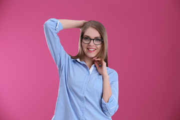 Young beautiful stylish woman on color background