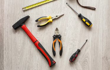 Desk of a carpenter with different tools. Studio shot on a wooden background