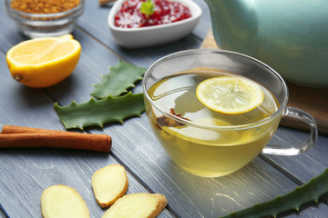 Cup of herbal tea on wooden table