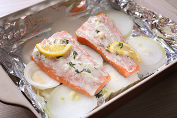 Delicious salmon fillet with cream sauce in baking dish