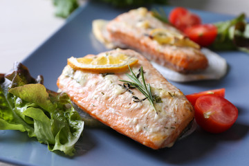 Delicious roasted salmon fillets on plate