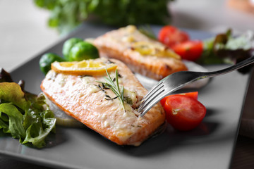 Delicious roasted salmon fillets on plate