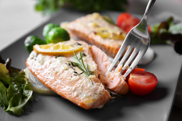 Delicious roasted salmon fillets on plate