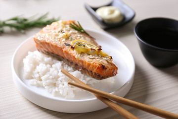 Delicious roasted salmon fillet with rice on white plate
