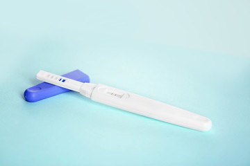 Pregnancy test on turquoise table