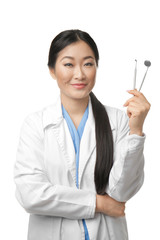 Pretty dentist standing on white background