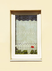 Decorated window on sand wall background