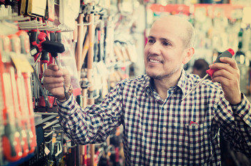 Pensioner selecting nails and hummer