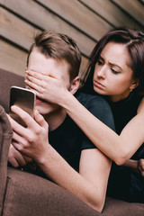 Young couple on sofa with smartphone