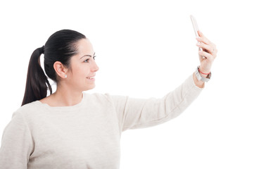 Beautiful female taking a  self portrait with cellphone