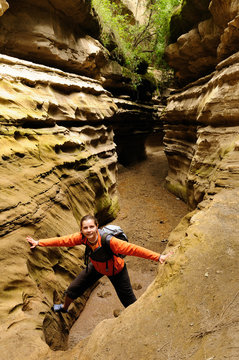 The tourist is exploring water-gouged gorges  in the Hells Gate National Park in Kenya