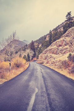Rocky Mountains asphalt road in autumn, color toned picture, Colorado, USA.