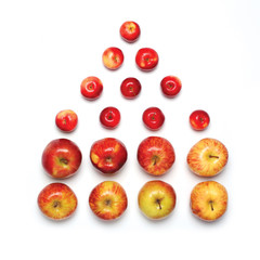 Colorful many red apples fruits in the form of a house isolated on a white background