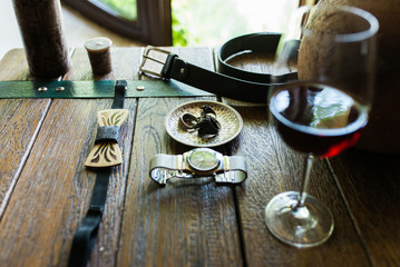 Wooden stylish necktie and other groom’s accessories on a wooden table