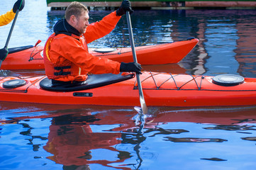 Obraz premium two man kayaking on the red kayak on the river 