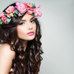 Perfect Brunette Model with Curly Hair and Flowers Wreath. Beautiful Woman with Makeup and Permed...