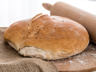 Round bun bread with a rolling pin