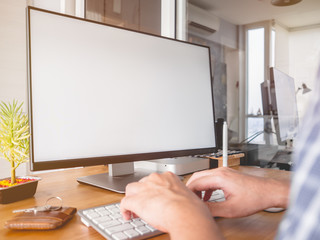 Creative freelance workspace with empty monitor.