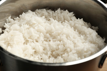 Cooked rice in metal saucepan, closeup