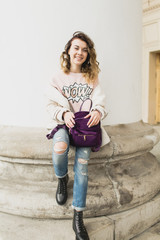 Young woman walking in the city in the spring