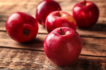 Fresh red apples on wooden background