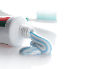 toothpaste and toothbrush on a white background