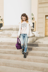 Young woman walking in the city in the spring