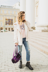 Young woman walking in the city in the spring