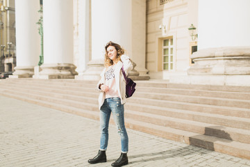 Young woman walking in the city in the spring