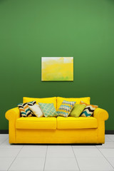Room interior with sofa on color wall background
