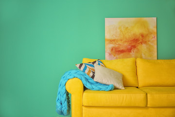 Room interior with sofa on color wall background