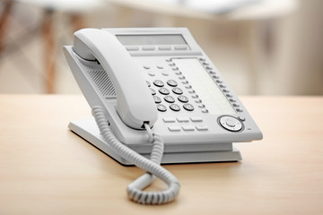 Telephone on wooden table in office