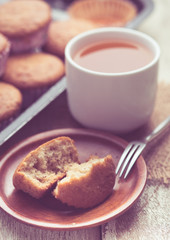 banana muffins cake with tea cup on wood background,vintage tone style