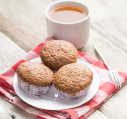 banana muffins cake with tea cup on wood background