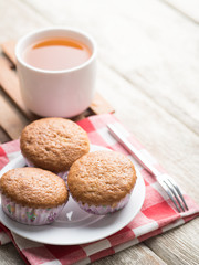 banana muffins cake with tea cup on wood background