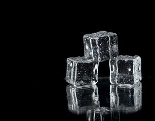 ice cubes on reflection table on black background