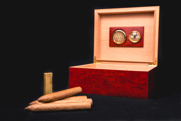 Cigar box on black background and lighter