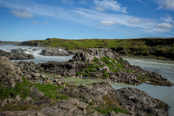 Naklejka na ściany i meble Green valley with river and waterfall. Icelandic landscape.