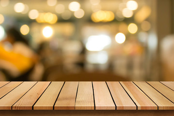 Wood table top on blur bokeh restaurant background can be used for display or montage your products
