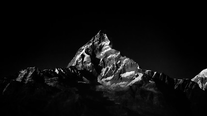 Machapuchare mountain peak in Himalaya. Black and white color.
