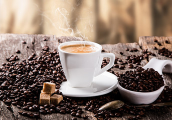 Coffee on a wooden table. Dark background.