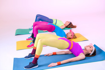 Fototapeta na wymiar young sporty women doing exercises on training mats