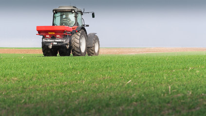 Tractor spreading artificial fertilizers